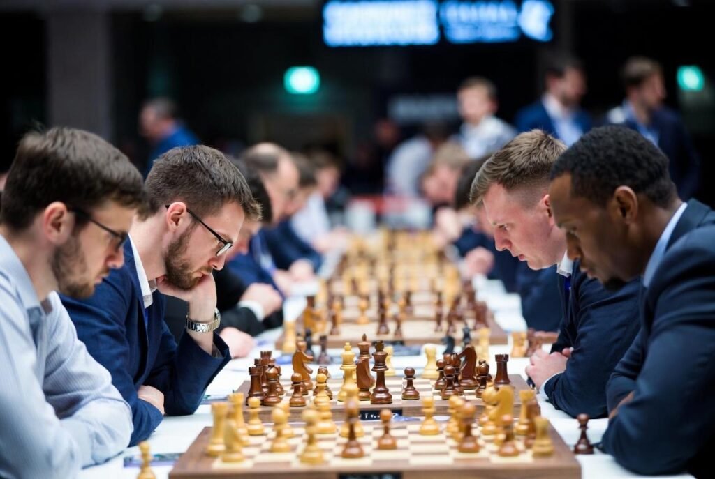 A chess grandmaster deep in thought, surrounded by books and pieces.