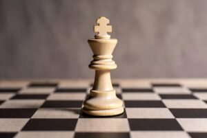 Alt text: A captivating photo of a grandmaster executing a game-winning checkmate in chess tournament.